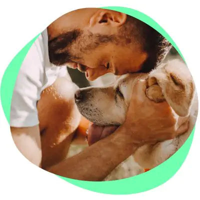man hugging dog