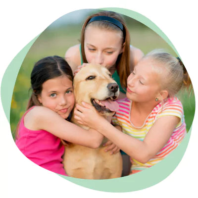 kids kissing and hugging a dog
